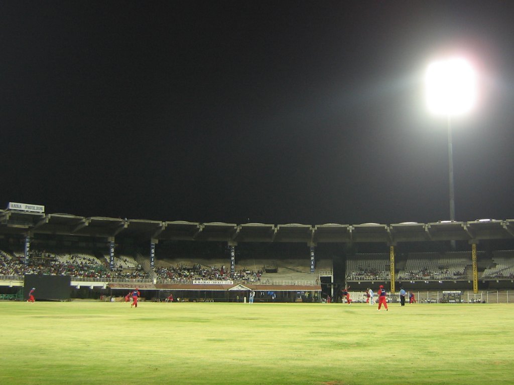 A floodlit night cricket match at a stadium in India