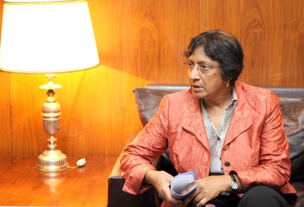Navanethem "Navi" Pillay seated in an office, holding notes