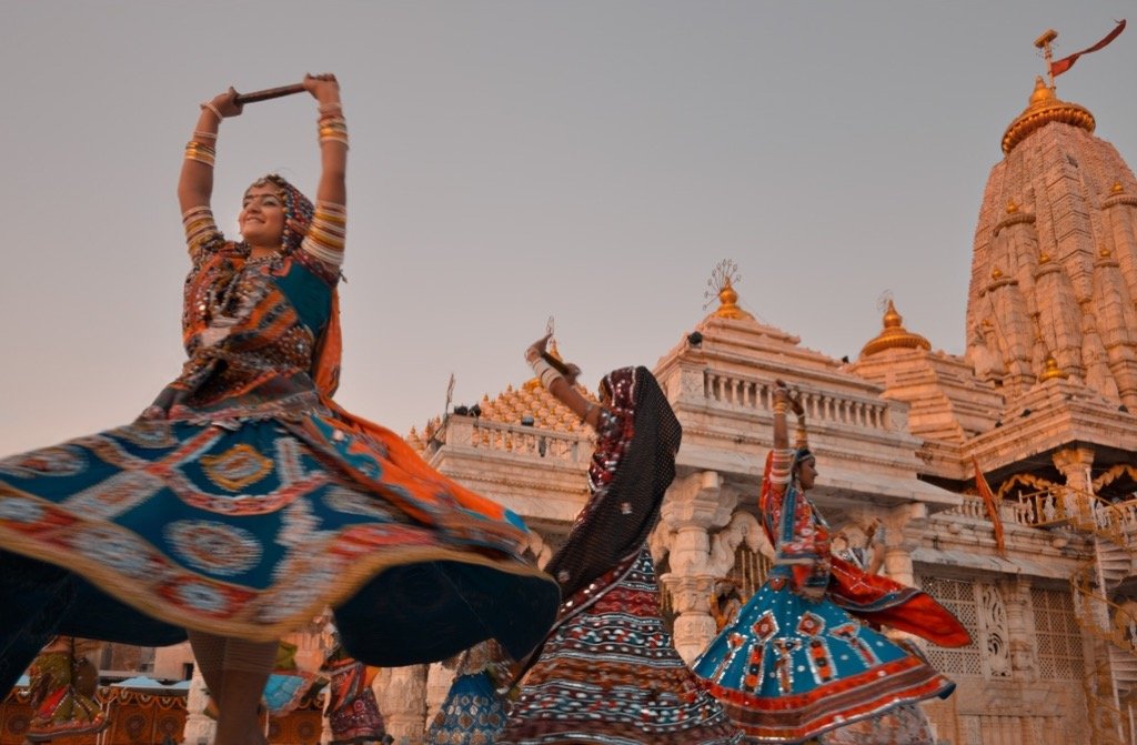 Women in colourful chaniya cholis dancing garba outside the Ambaji temple in Gujarat