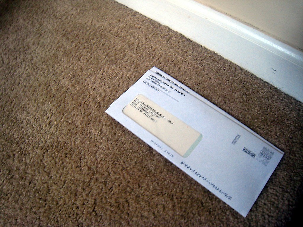 An envelope from the Social Security Administration lying on a carpet