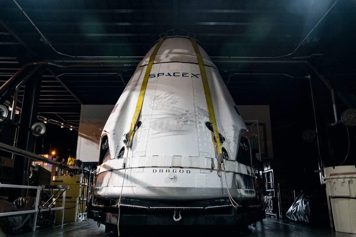 A SpaceX Crew Dragon capsule, scorched from re-entry, after recovery